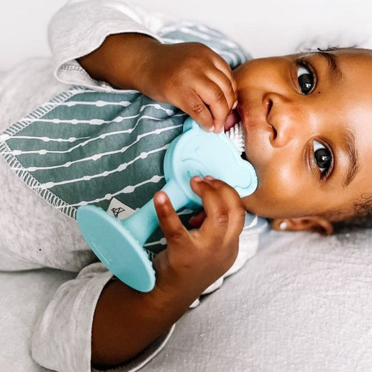 baby holding oogiebear 360° teething toothbrush