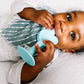 baby holding oogiebear 360° teething toothbrush